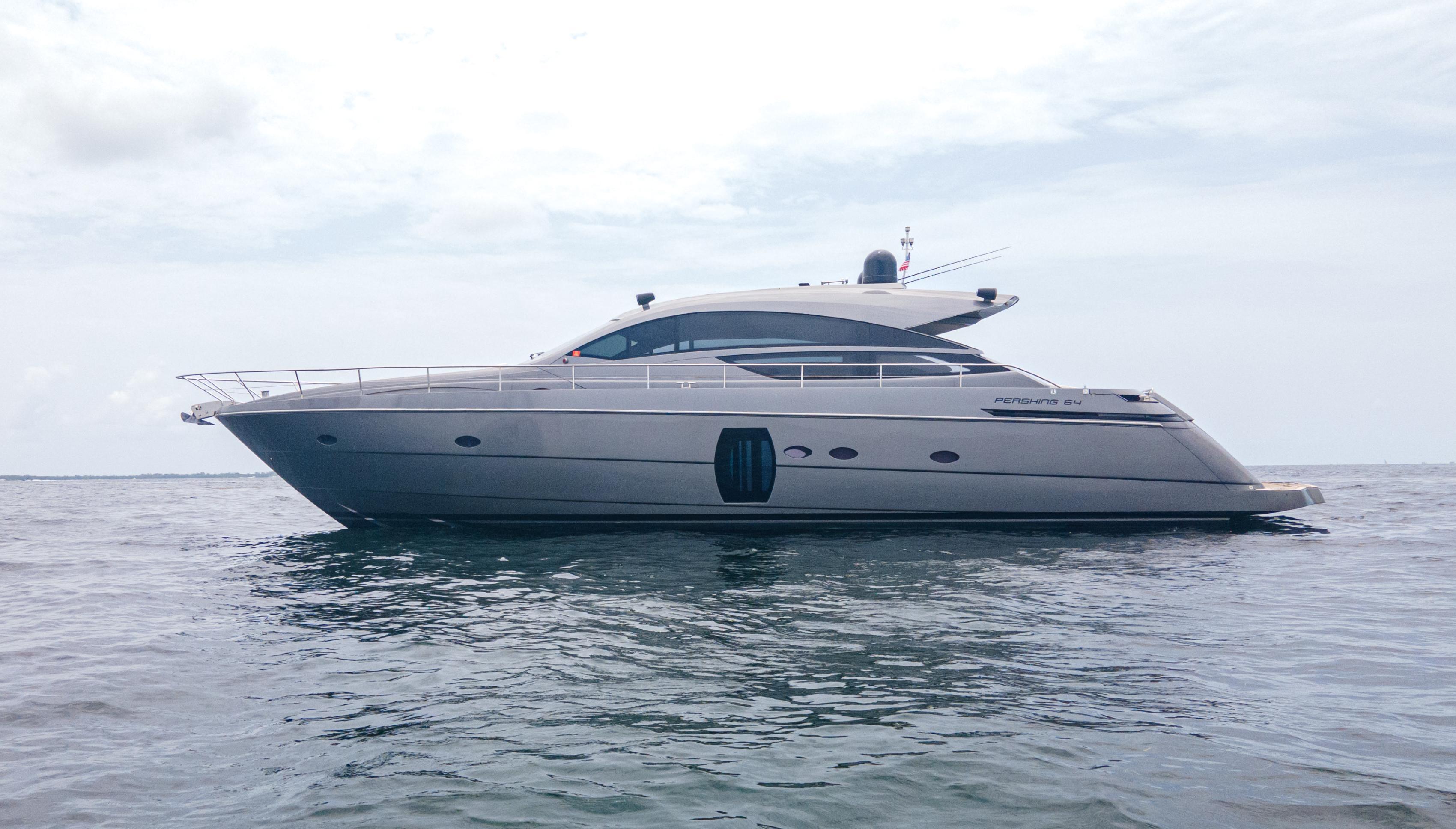 2009 Pershing 64 yacht on calm sea under cloudy sky.
