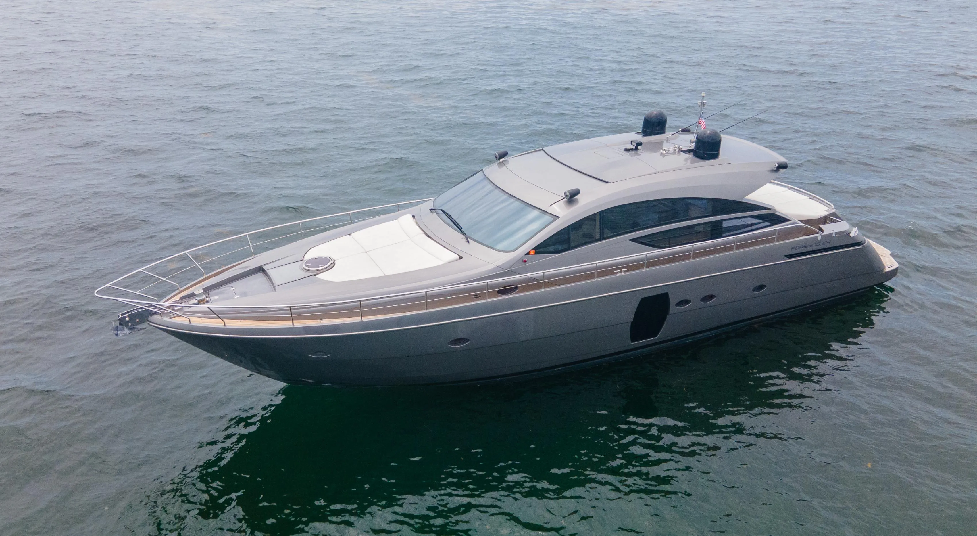 2009 Pershing 64 yacht on calm water, showcasing sleek design and luxury features.