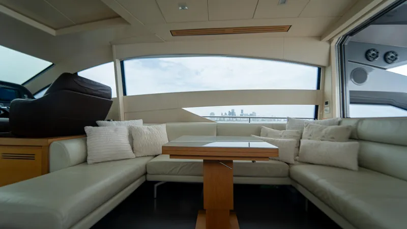Wind Yacht Photos Pics Luxurious interior of a 2009 Pershing 64 yacht with plush seating and city skyline view.