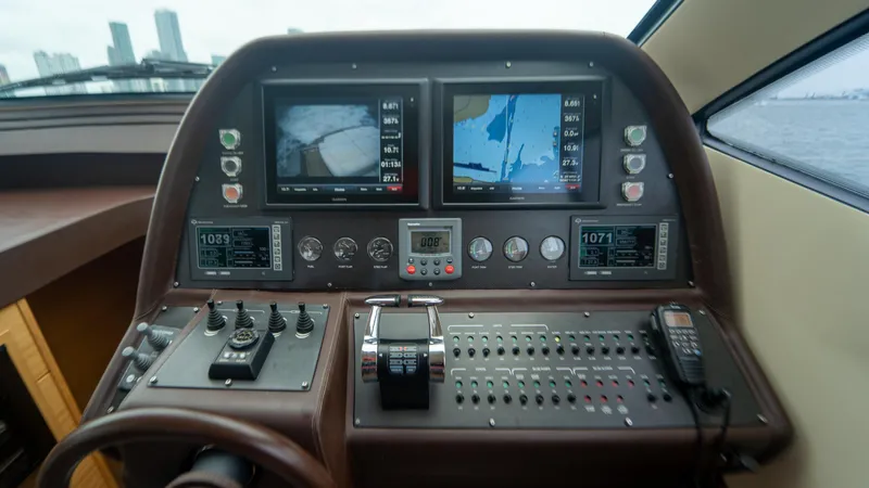 Wind Yacht Photos Pics Control panel of a 2009 Pershing 64 yacht with navigation screens and controls.