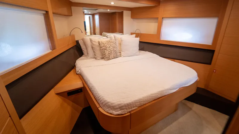 Wind Yacht Photos Pics Luxurious bedroom interior of 2009 Pershing 64 yacht with modern wood finish.