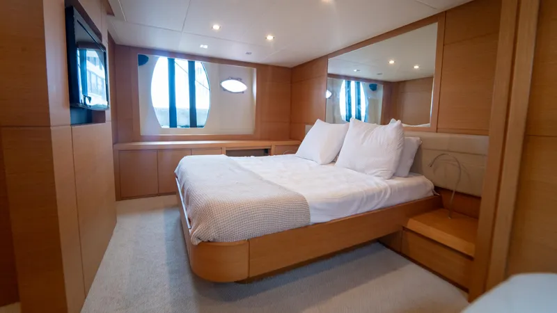 Wind Yacht Photos Pics Luxurious bedroom interior of 2009 Pershing 64 yacht with modern design and cozy bedding.