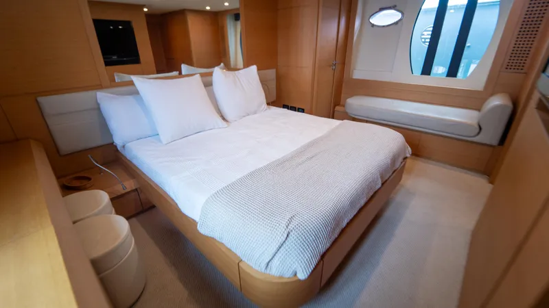 Wind Yacht Photos Pics Luxurious bedroom interior of 2009 Pershing 64 yacht with modern design and cozy bedding.