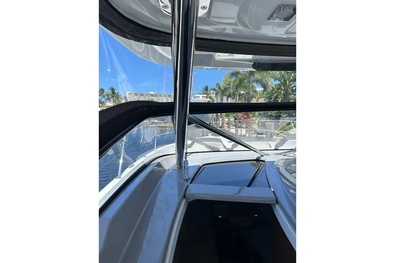  Yacht Photos Pics 2022 Jeanneau Leader 12.5 WA boat interior with clear view of marina and palm trees.