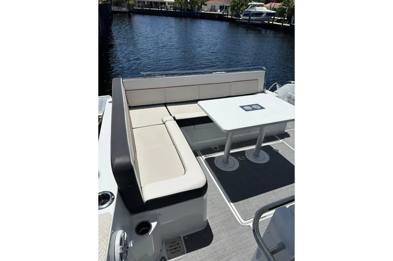  Yacht Photos Pics 2022 Jeanneau Leader 12.5 WA boat with seating and table on deck.