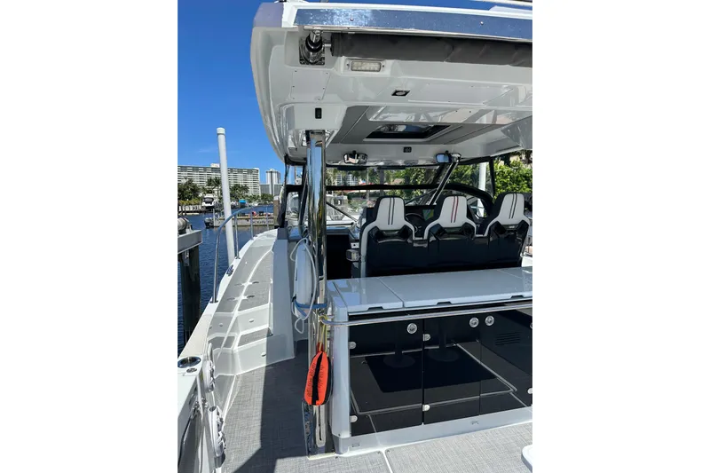  Yacht Photos Pics 2022 Jeanneau Leader 12.5 WA boat interior with seating and helm, docked at marina.