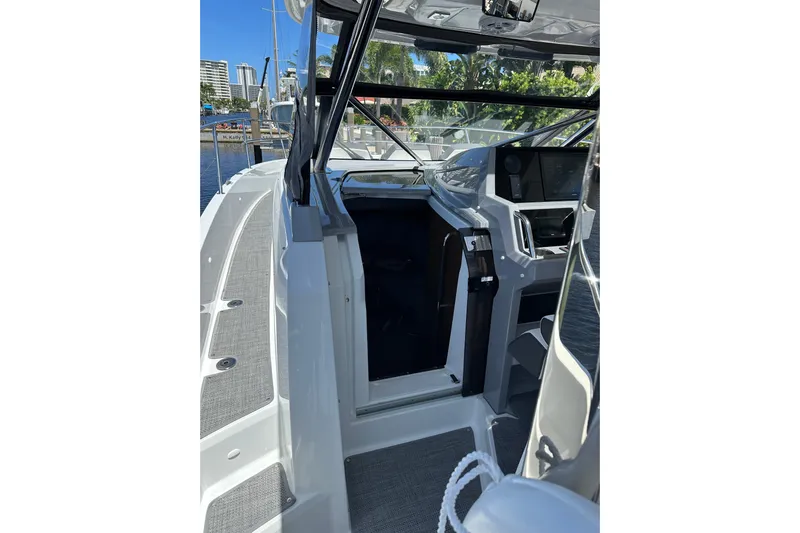  Yacht Photos Pics 2022 Jeanneau Leader 12.5 WA boat interior with helm and open cabin door.