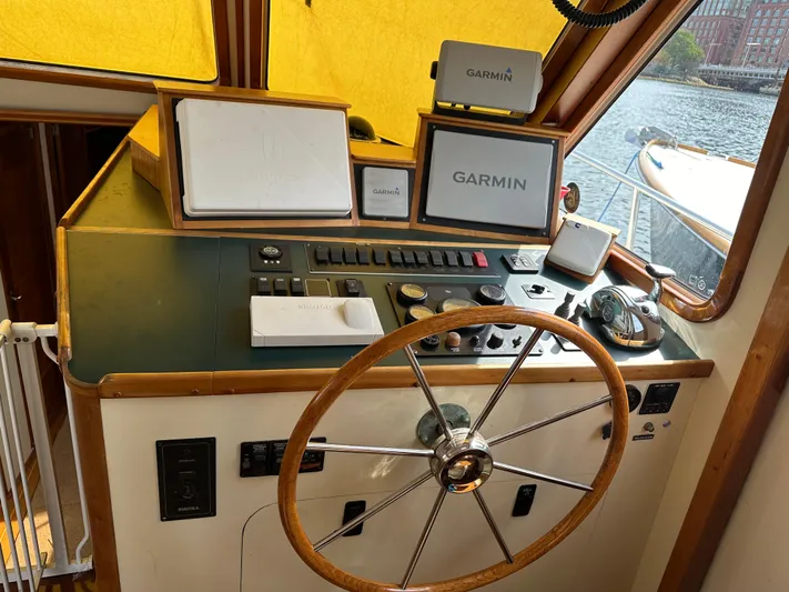 Blue Sora Yacht Photos Pics Helm of 2005 Legacy 42 boat with Garmin navigation equipment and wooden steering wheel.