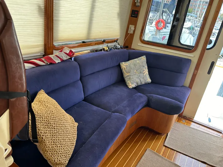 Blue Sora Yacht Photos Pics Interior of 2005 Legacy 42 boat with blue sofa and decorative pillows.