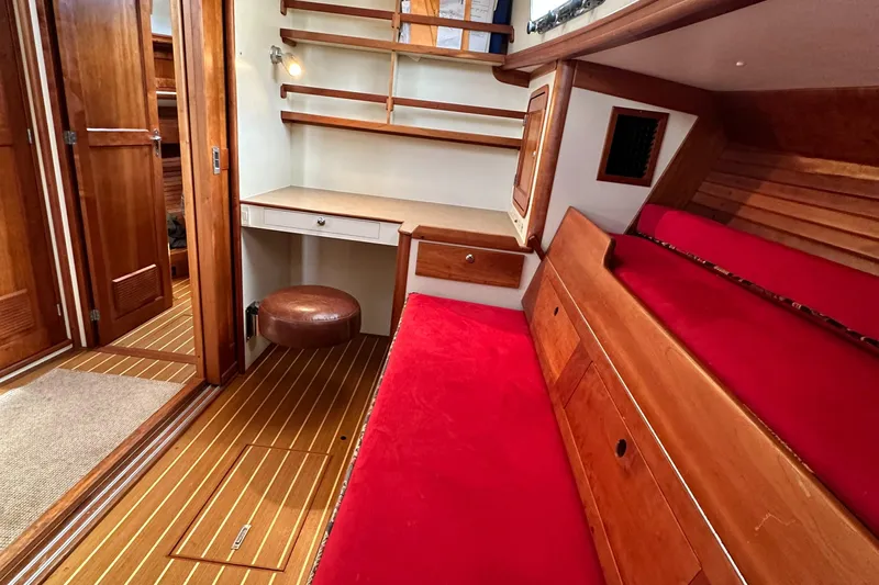 Blue Sora Yacht Photos Pics Interior of 2005 Legacy 42 boat with red seating and wooden accents.