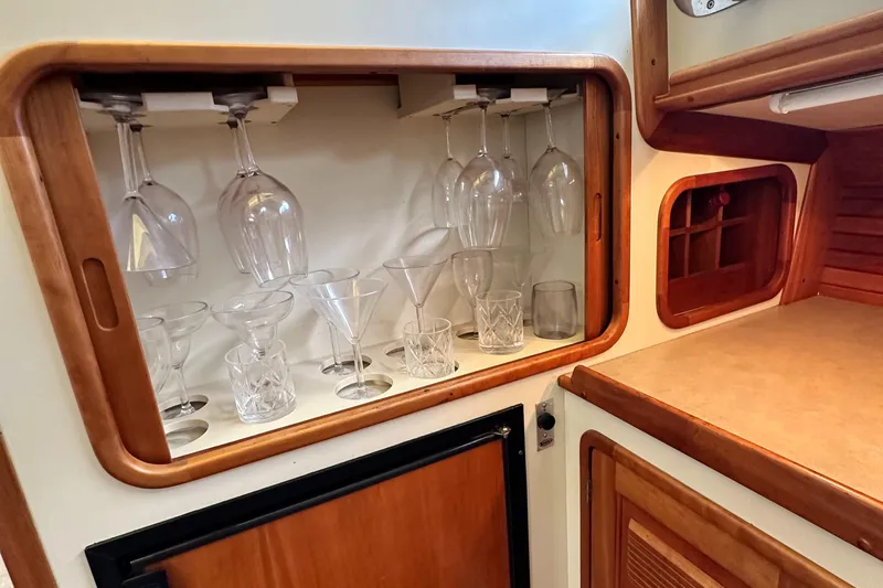 Blue Sora Yacht Photos Pics Glassware storage in a 2005 Legacy 42 yacht interior, featuring wine and cocktail glasses.