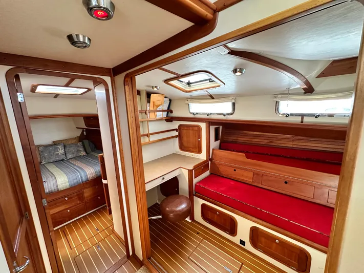 Blue Sora Yacht Photos Pics Luxurious interior of 2005 Legacy 42 yacht with wood accents and red seating.