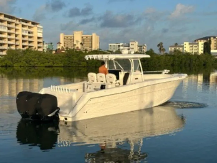  Yacht Photos Pics 2017 Stamas 390 Tarpon boat on calm water near urban buildings.