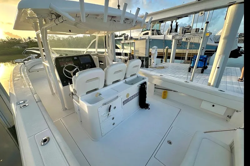  Yacht Photos Pics 2017 Stamas 390 Tarpon boat interior with helm, seating, and fishing rod holders at dock.