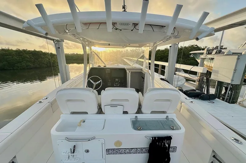  Yacht Photos Pics 2017 Stamas 390 Tarpon boat interior with helm, seats, and fishing rod holders at sunset.