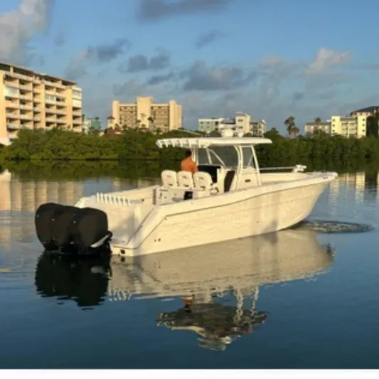  Yacht Photos Pics 2017 Stamas 390 Tarpon boat on calm water near urban buildings.
