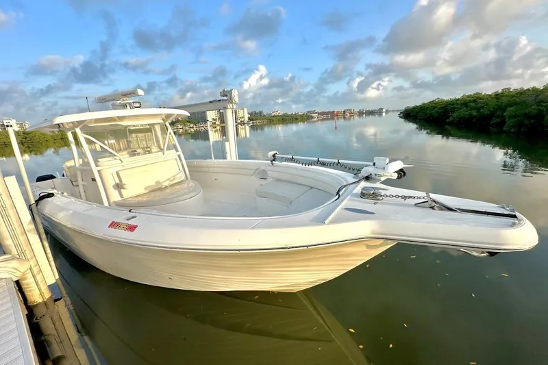  Yacht Photos Pics 2017 Stamas 390 Tarpon boat docked on calm water under a blue sky.