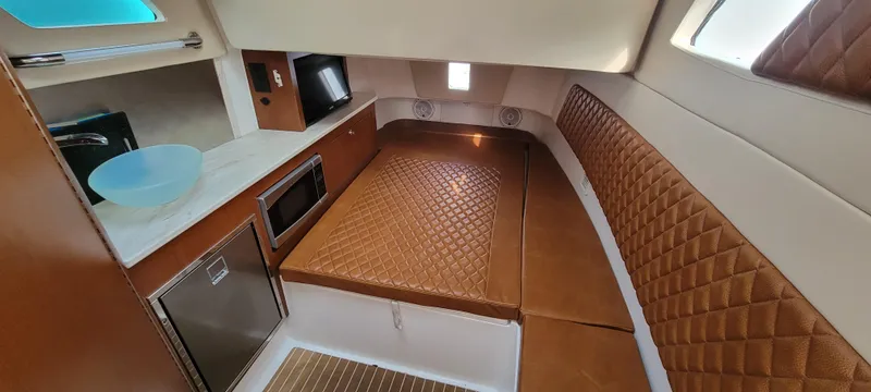  Yacht Photos Pics Interior of 2018 Edgewater 370CC boat with kitchen and seating area.