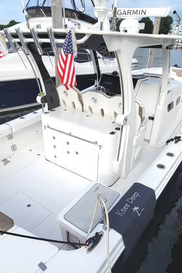  Yacht Photos Pics 2018 Edgewater 370CC boat docked, featuring American flag and Garmin equipment.