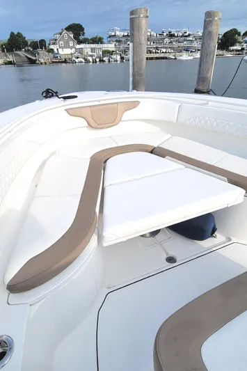  Yacht Photos Pics 2018 Edgewater 370CC boat with spacious seating, docked by a serene waterfront.