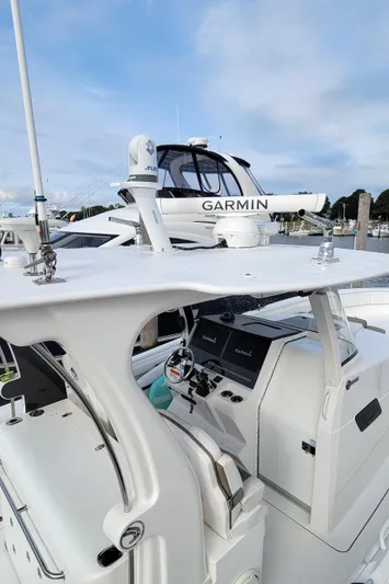  Yacht Photos Pics 2018 Edgewater 370CC boat with Garmin equipment, docked under a clear sky.