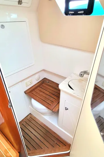  Yacht Photos Pics 2018 Edgewater 370CC boat bathroom with wooden accents and compact sink.