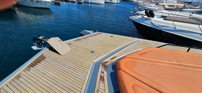  Yacht Photos Pics Sunreef 40 Power 2019 yacht deck with orange seating, docked in a marina.