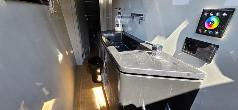  Yacht Photos Pics Modern bathroom interior on 2019 Sunreef 40 Power yacht, featuring sleek sink and control panel.