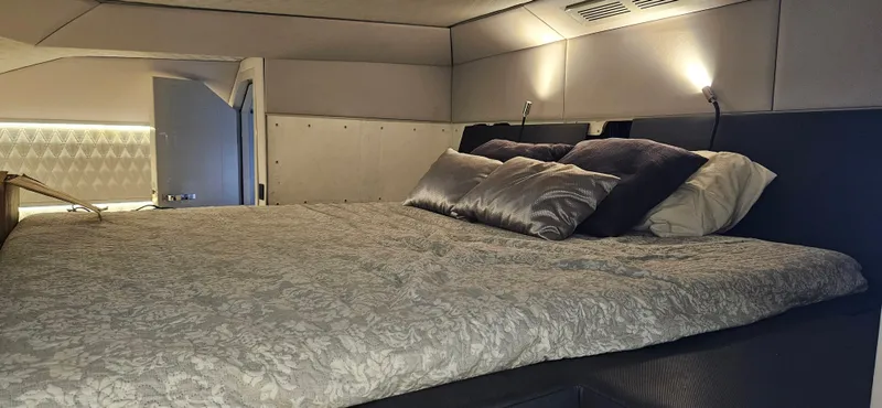  Yacht Photos Pics Luxurious bedroom interior of 2019 Sunreef 40 Power yacht with elegant bedding and ambient lighting.