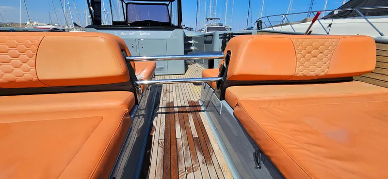  Yacht Photos Pics Sunreef 40 Power 2019 yacht with orange seating and wooden deck, docked at a marina.