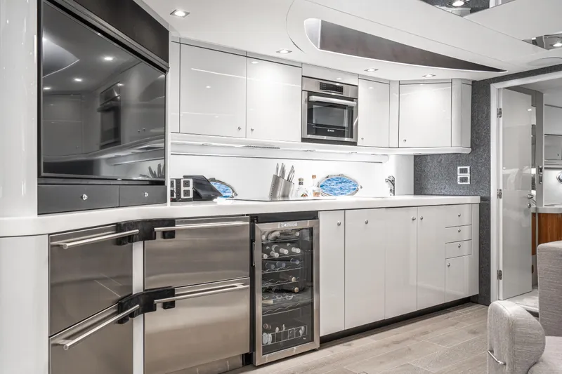  Yacht Photos Pics Luxurious kitchen interior of 2021 Sunseeker Predator 68 yacht with modern appliances.