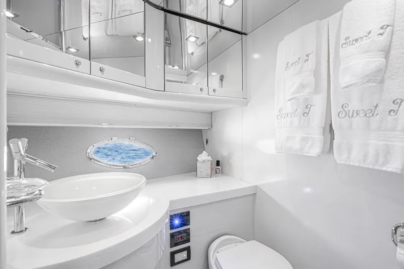  Yacht Photos Pics Luxurious bathroom in 2021 Sunseeker Predator 68 yacht with elegant fixtures and ocean view.