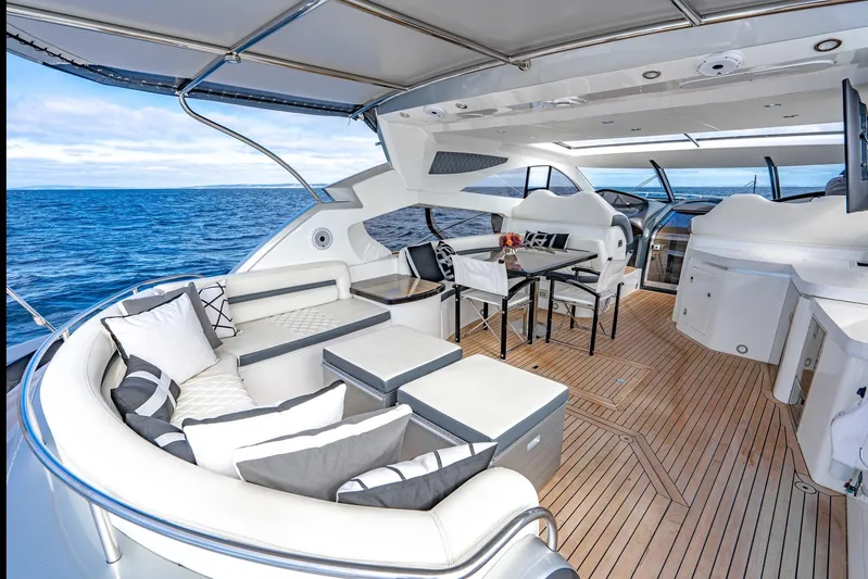  Yacht Photos Pics Luxurious Sunseeker Predator 68 yacht interior, 2021 model, featuring elegant seating and ocean view.