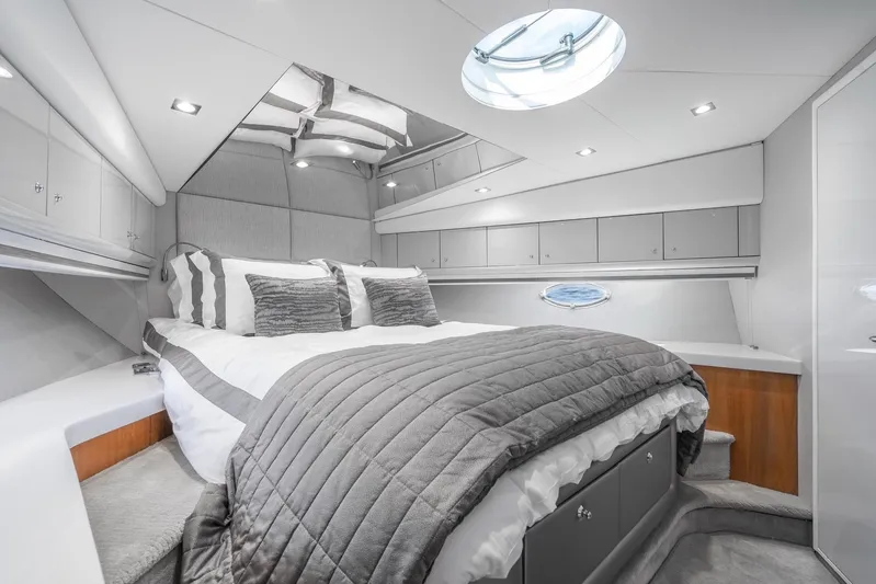  Yacht Photos Pics Luxurious bedroom interior of 2021 Sunseeker Predator 68 yacht, featuring modern design and elegant decor.