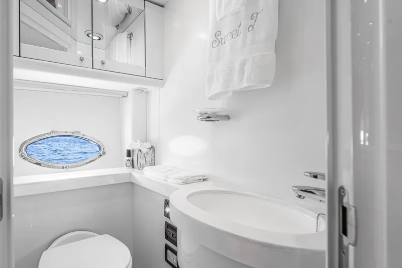  Yacht Photos Pics Luxurious bathroom in 2021 Sunseeker Predator 68 yacht with ocean view porthole.