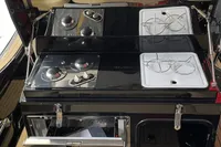 2022 Zar Formenti 85 SL boat kitchen with dual-burner stove and storage compartments.