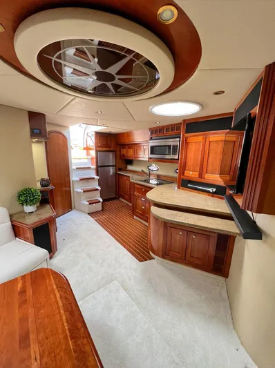 Cla Cla Yacht Photos Pics Luxurious 2011 Cruisers Yachts 560 Express interior with elegant wood finishes and modern amenities.