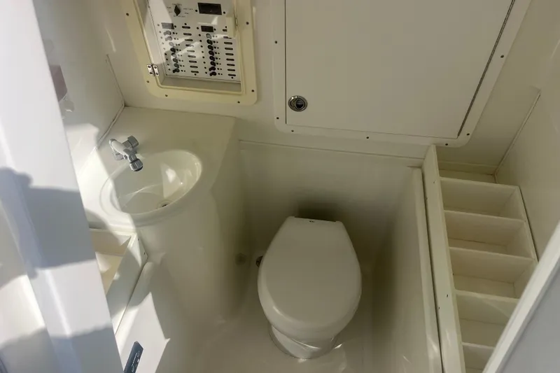 Bluefin Yacht Photos Pics 2017 SeaVee 370Z boat bathroom with sink, toilet, and control panel.