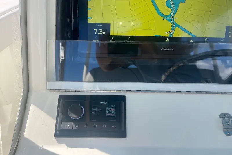 Bluefin Yacht Photos Pics Garmin navigation display on 2017 SeaVee 370Z boat dashboard with Fusion audio system.