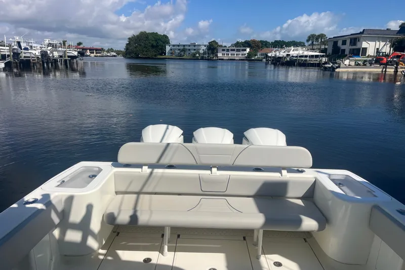 Bluefin Yacht Photos Pics 2017 SeaVee 370Z boat with triple engines docked in a serene marina setting.