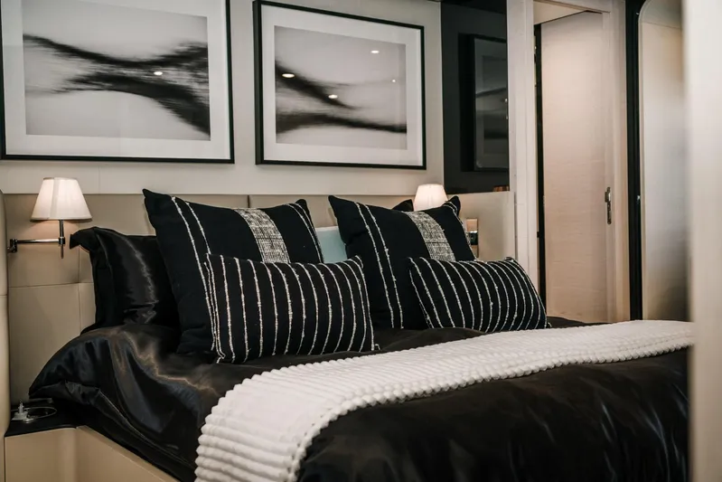  Yacht Photos Pics Luxurious bedroom interior on a 2014 Azimut 80 yacht, featuring elegant black bedding and modern decor.
