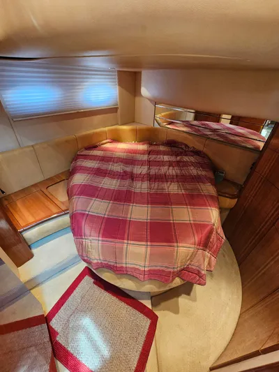 Bella Vita Yacht Photos Pics Cozy bedroom interior of 2003 Azimut 46 MY yacht with plaid bedding and warm lighting.