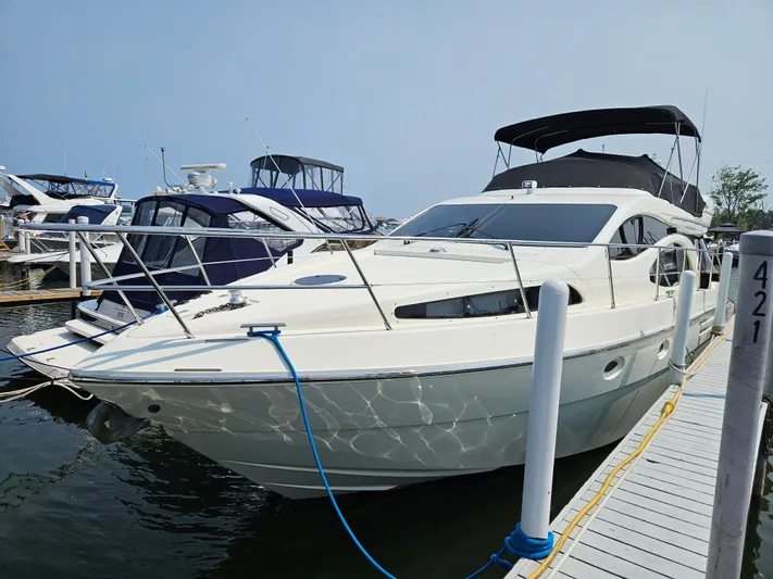 Bella Vita Yacht Photos Pics 2003 Azimut 46 MY yacht docked at marina, featuring sleek design and spacious deck.