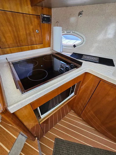 Bella Vita Yacht Photos Pics Luxurious kitchen area in 2003 Azimut 46 MY yacht with modern stovetop.