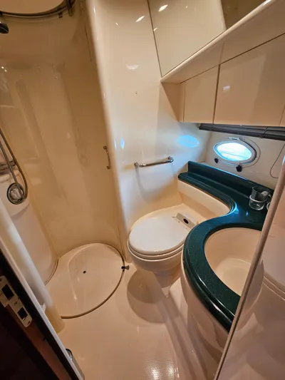 Bella Vita Yacht Photos Pics 2003 Azimut 46 MY yacht bathroom with shower, toilet, and porthole window.