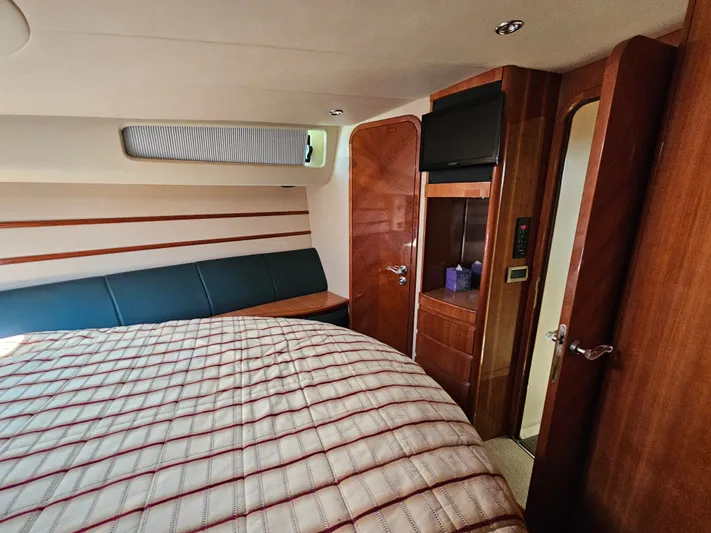 Bella Vita Yacht Photos Pics Luxurious cabin interior of 2003 Azimut 46 MY yacht with wood finishes and cozy bedding.