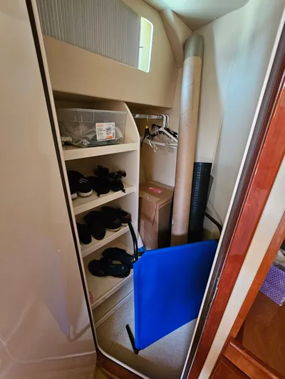 Bella Vita Yacht Photos Pics Storage closet inside a 2003 Azimut 46 MY yacht, featuring shelves and various items.