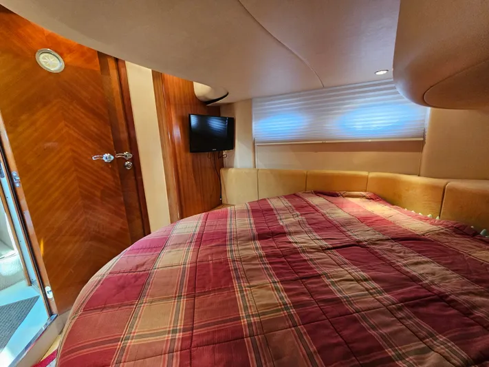 Bella Vita Yacht Photos Pics Luxurious cabin interior of 2003 Azimut 46 MY yacht with cozy bed and TV.