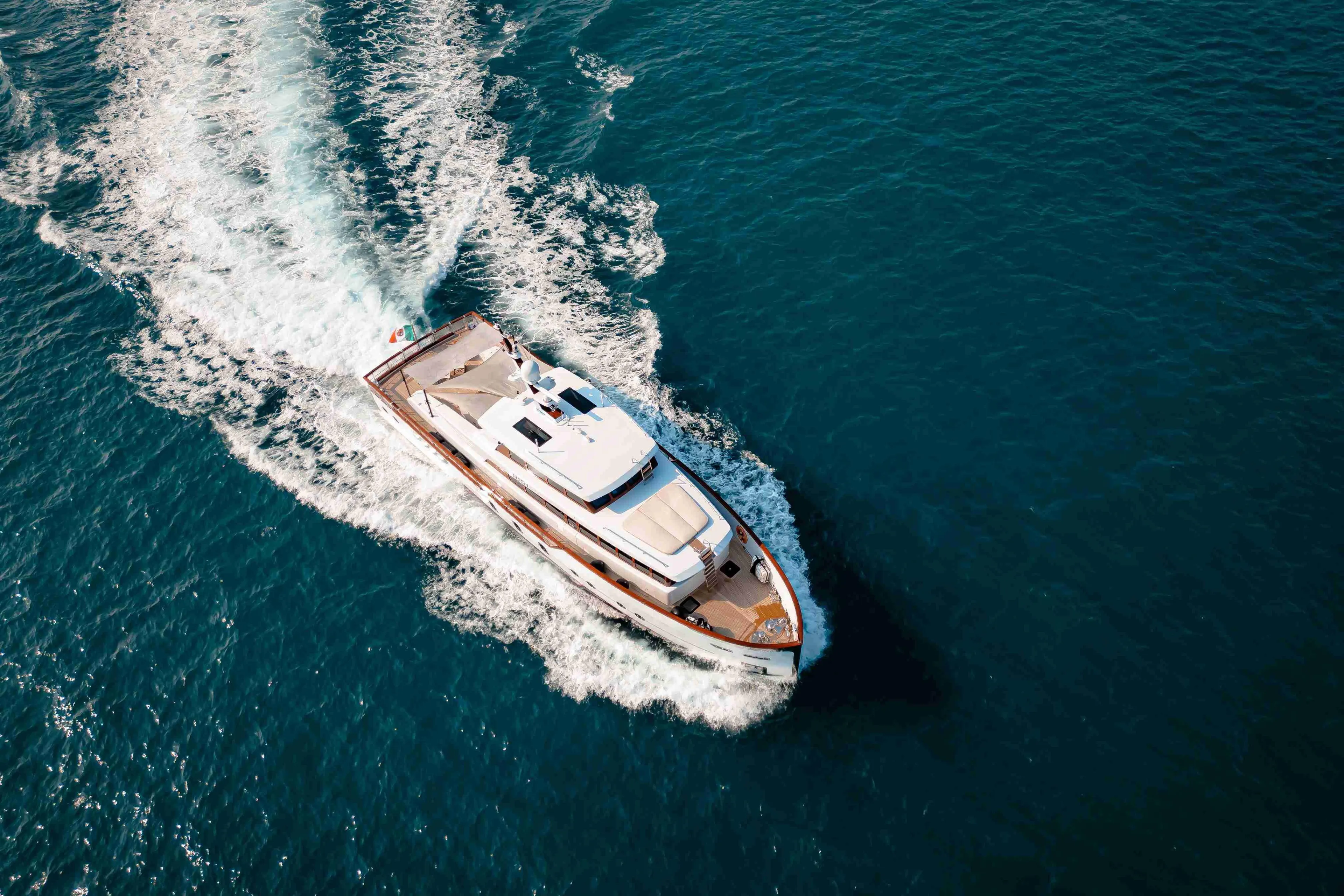 Aerial view of 2024 Codecasa F242 yacht cruising on open sea.