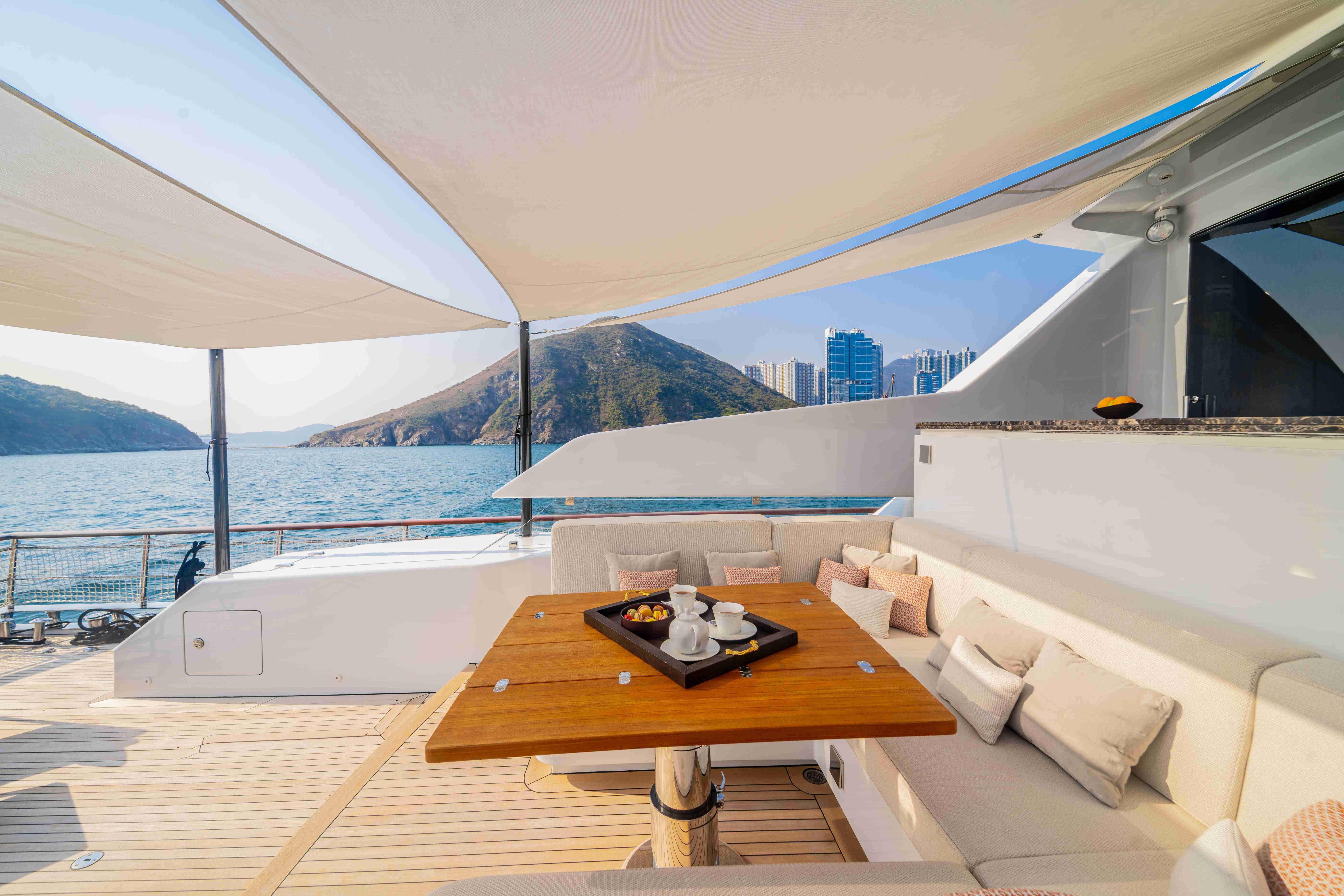 Luxurious Codecasa F242 yacht deck with elegant seating, table, and ocean view, 2024 model.